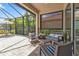 Relaxing screened porch with patio furniture and view of lush landscaping at 13064 Creekside Ln, Port Charlotte, FL 33953