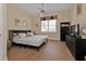 Spacious bedroom with a king-size bed, built-in shelving, and wood-look floors at 13064 Creekside Ln, Port Charlotte, FL 33953