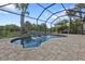 Inviting kidney shaped pool with waterfall features at 13064 Creekside Ln, Port Charlotte, FL 33953