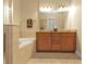 Bathroom with double vanity, granite countertop, and a large soaking tub at 13064 Creekside Ln, Port Charlotte, FL 33953