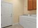 Laundry room with washer, dryer, and built-in cabinets at 13064 Creekside Ln, Port Charlotte, FL 33953