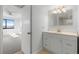 Updated bathroom with white vanity and a view of the bedroom at 1500 Park Beach Cir # 4A, Punta Gorda, FL 33950