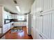 White kitchen with lots of cabinet space and wood flooring at 743 Tangerine Woods Blvd, Englewood, FL 34223