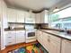 White kitchen with stainless steel appliances and a tile backsplash at 743 Tangerine Woods Blvd, Englewood, FL 34223