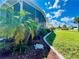 Landscaped front yard with palm trees and garden accents at 743 Tangerine Woods Blvd, Englewood, FL 34223