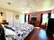 Main bedroom with wood floors, a TV, and natural light at 743 Tangerine Woods Blvd, Englewood, FL 34223