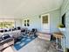 Relaxing screened porch with wicker furniture and view of the yard at 743 Tangerine Woods Blvd, Englewood, FL 34223