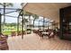 Screened lanai with wicker furniture for relaxing at 743 Tangerine Woods Blvd, Englewood, FL 34223