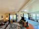 Spacious living room with hardwood floors, large windows, and comfortable seating at 743 Tangerine Woods Blvd, Englewood, FL 34223
