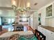 Bright kitchen with white cabinets, island, and stainless steel appliances at 743 Tangerine Woods Blvd, Englewood, FL 34223