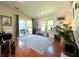 Home office with wood floors, desk, and access to patio at 743 Tangerine Woods Blvd, Englewood, FL 34223