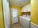 Laundry room with washer, dryer, and exterior access at 743 Tangerine Woods Blvd, Englewood, FL 34223