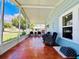 Spacious screened porch with tile flooring and wicker furniture at 743 Tangerine Woods Blvd, Englewood, FL 34223