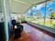 Spacious screened porch with tiled floor, wicker chairs, and a view at 743 Tangerine Woods Blvd, Englewood, FL 34223