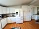 Bright kitchen with white cabinets, stainless steel appliances, and ample storage at 743 Tangerine Woods Blvd, Englewood, FL 34223