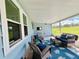 Relaxing screened porch with wicker furniture and view of the yard at 743 Tangerine Woods Blvd, Englewood, FL 34223