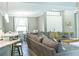 Open living room with gray sectional sofa and dining area view at 5148 Guava Ter, Port Charlotte, FL 33981