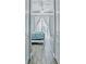 Bright bedroom with whitewashed wood bed frame, blue bedding, and sliding glass doors to the pool at 5148 Guava Ter, Port Charlotte, FL 33981