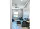 Living room with sectional sofa, wood-look tile floors, and large window at 5148 Guava Ter, Port Charlotte, FL 33981