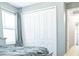 Bedroom with built-in closet and window with blinds at 5148 Guava Ter, Port Charlotte, FL 33981