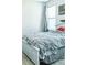 Cozy bedroom with gray bedding and a window with blinds at 5148 Guava Ter, Port Charlotte, FL 33981