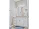 Bathroom with double vanity, granite countertop, and white cabinets at 5148 Guava Ter, Port Charlotte, FL 33981