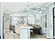 Open-concept kitchen and living area with white cabinets and granite island at 5148 Guava Ter, Port Charlotte, FL 33981