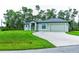 Single-story home with two-car garage and landscaped lawn at 5148 Guava Ter, Port Charlotte, FL 33981