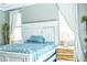 Bedroom with whitewashed headboard, blue bedding and light wood nightstands at 5148 Guava Ter, Port Charlotte, FL 33981