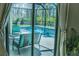 Inviting pool area with patio furniture, screened enclosure, and lush landscaping at 5148 Guava Ter, Port Charlotte, FL 33981