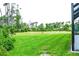 Spacious backyard with lush grass and a view of neighboring properties at 5148 Guava Ter, Port Charlotte, FL 33981