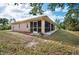 Backyard view of home with a screened patio at 11786 De Miranda Ave, North Port, FL 34287