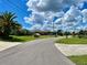 Quiet residential street with lush landscaping and single-Gathering homes at 181 N Waterway Nw Dr, Port Charlotte, FL 33952