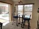 Bright breakfast nook with glass-top table and two chairs, overlooking the pool and canal at 181 N Waterway Nw Dr, Port Charlotte, FL 33952