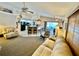 Open concept living room showcasing kitchen and access to backyard patio at 181 N Waterway Nw Dr, Port Charlotte, FL 33952