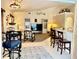 Open living room with a TV, comfortable seating, and access to the kitchen and bar at 181 N Waterway Nw Dr, Port Charlotte, FL 33952