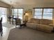Bright living room featuring a comfortable couch and rocking chair, adjacent to a dining area at 181 N Waterway Nw Dr, Port Charlotte, FL 33952