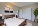 Bedroom features a bed with a wooden headboard, large windows, and plant decor at 2513 Elkcam Blvd, Port Charlotte, FL 33952