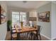 Dining room showcases a large wooden table, stylish decor, and ample natural light at 2513 Elkcam Blvd, Port Charlotte, FL 33952