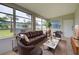 Bright sun room features ample seating, large windows, and lots of natural light at 2513 Elkcam Blvd, Port Charlotte, FL 33952