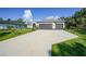 Traditional home featuring a three-car garage, manicured lawn, and neutral paint at 4767 Maurbach Ter, North Port, FL 34286