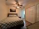 Bedroom with double bed, closet, and ceiling fan at 829 Pineland Ave, Venice, FL 34285