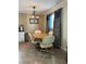 Bright dining area with wood table and four off-white chairs at 829 Pineland Ave, Venice, FL 34285
