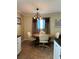 Cozy dining area with a wood table and four off-white chairs at 829 Pineland Ave, Venice, FL 34285