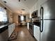 Eat-in kitchen with white cabinets, granite counters, and stainless steel appliances at 829 Pineland Ave, Venice, FL 34285