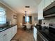 Eat-in kitchen with white cabinets, granite counters, and stainless steel appliances at 829 Pineland Ave, Venice, FL 34285