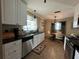 Open concept kitchen with white cabinets, granite countertops, and a breakfast nook at 829 Pineland Ave, Venice, FL 34285