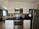 Modern kitchen featuring stainless steel appliances and granite countertops at 829 Pineland Ave, Venice, FL 34285