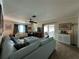 Bright living room with light blue sectional sofa and tile floors at 829 Pineland Ave, Venice, FL 34285