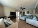 Bright living room with light blue sectional sofa and tile floors at 829 Pineland Ave, Venice, FL 34285